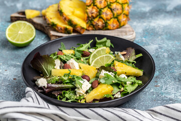 Mediterranean vegetarian salad with aleaves of pineapple, blue cheese. almond. Vegetarian or healthy food. Top view
