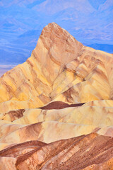 Death Valley iconic Zabriskie Point mountain peak with colorful waves of sediment