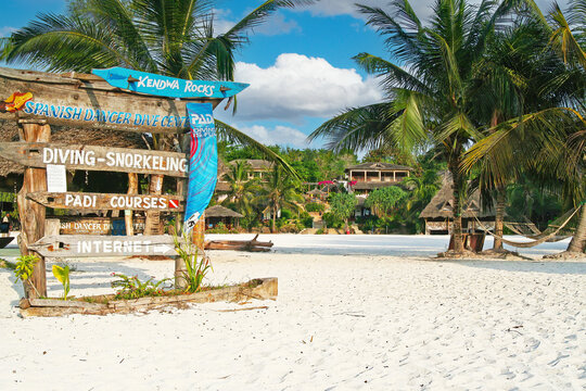 Kendwa, Zanzibar - December 9. 2007: Relaxing tropical seaside resort, white sand beach, palm trees, diving padi courses sign