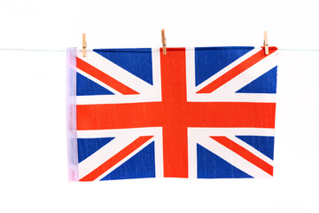 Fototapeta na wymiar British flag tied with a clothespin to a rope on a white background