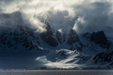 Dramatic mountain landscape in Svalbard. In the foreground the Greenland Sea.