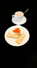 two spring rolls and sweet and sour sauce with a cup of coffee latte