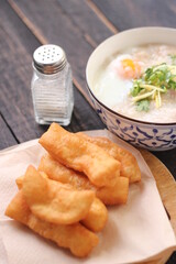 Congee in a Thai-patterned cup and fried dough are Thai food and street food popular to eat in the morning