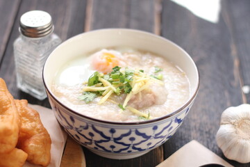 Congee in a Thai-patterned cup and fried dough are Thai food and street food popular to eat in the morning