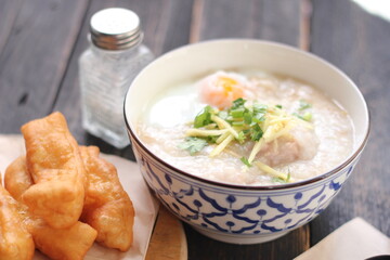 Congee in a Thai-patterned cup and fried dough are Thai food and street food popular to eat in the morning