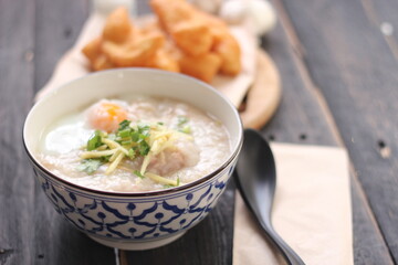 Congee in a Thai-patterned cup and fried dough are Thai food and street food popular to eat in the morning