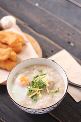 Congee in a Thai-patterned cup and fried dough are Thai food and street food popular to eat in the morning