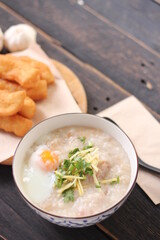 Congee in a Thai-patterned cup and fried dough are Thai food and street food popular to eat in the morning