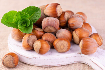 Hazelnuts on a white wooden board. Close-up.
