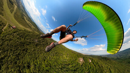 Man flying the paragliding at sunny day, adventure concept © Rick Neves
