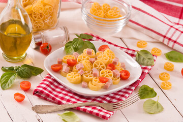 Ruote pasta with tomato and ham.