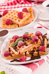 Waffles with raspberries and chocolate cream.