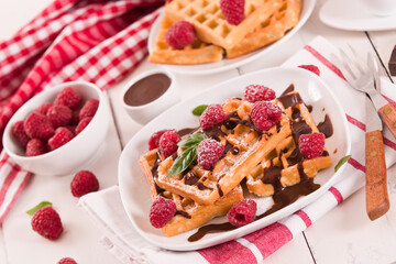 Waffles with raspberries and chocolate cream.
