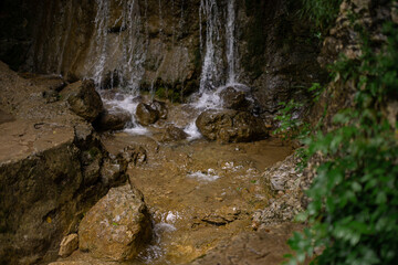 The course of a mountain river. Hiking in the forest. Natural background with water.