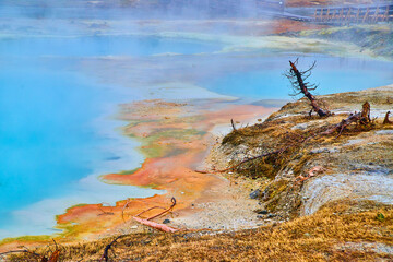 Dangerous alkaline pools with blue depths in Yellowstone basin