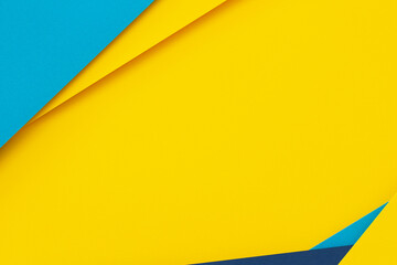 Abstract color papers geometry flat lay composition background with blue and yellow tones