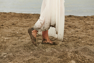 female feet on a background of wet sand