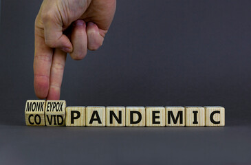 Monkeypox or covid pandemic symbol. Changed concept words Covid pandemic to Monkeypox pandemic on wooden blocks. Doctor hand. Medical and monkeypox or covid pandemic concept. Copy space.