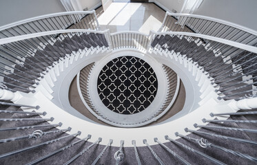 Fototapeta premium elegant stairs spiral down to lower level