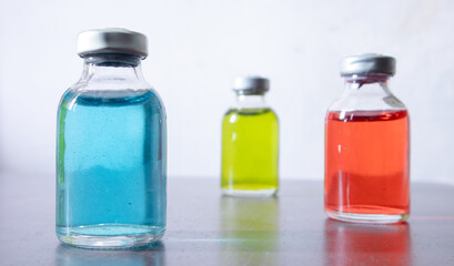 Three vial of color solution are arranged in position. the blue one is focused.