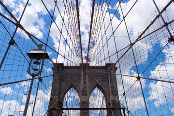 The Brooklyn bridge and the American flag, New York City. USA.