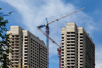 Fototapeta na wymiar Tower crane on new buildings of the city.