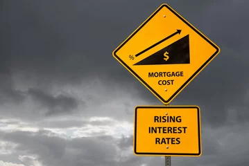 Fotobehang Conceptual road sign about rising interest rates and mortgage costs with storm sky in background. Business and finance concept. Copy space. © alpegor