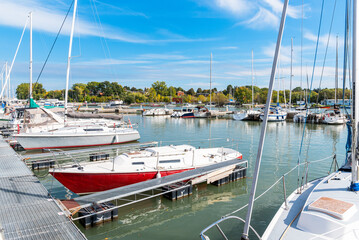 Fototapeta premium Yachts in a harbour on a lake on a bright sunny day in autumn
