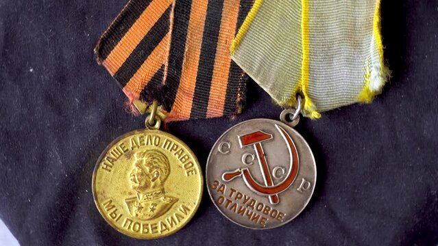 USSR medals. Soviet medals. Victory in WWII. The victory of the Russian people. Image of Stalin. Hammer and sickle. Reward for victory. Labor reward. Gold. Silver. Close-up. Object rotation. The symbo