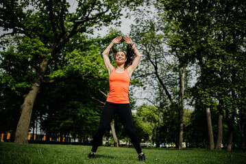 Jumping woman in the park. Sport