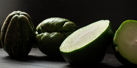 Fresh green traditional latin fruit on black wooden table	