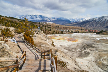 Boardwalk leading through hot spring terraces in Yellowstone winter