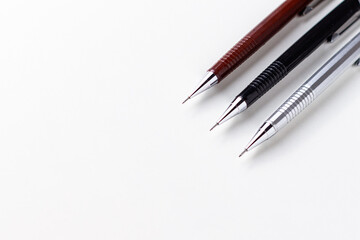 Three mechanical pencils of different sizes on the white background.