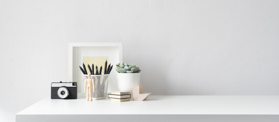 Office desk with office supplies and empty table space.