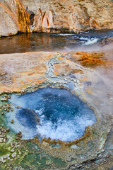 Amazing chinese bubbling hot spring by river in Yellowstone