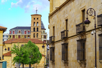 Old buildings with Romanesque church in the background in the medieval town of Leon, Spain.