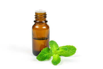 Essential oil of fragrant mint (peppermint) in a dark glass bottle with a dispenser on a white isolated background. Aromatherapy (against fatigue, headache, relaxation), spa.