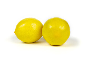 Two fresh beautiful yellow lemons on a white isolated background close-up.