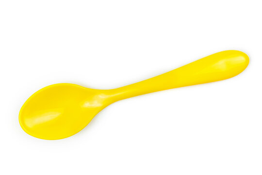 Bright yellow plastic spoon for feeding the baby on a white isolated background.
