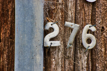 Detail of number 276 on wood telephone pole - Powered by Adobe