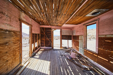 Inside abandoned and decaying wood room in desert - Powered by Adobe