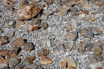 Colored rocks and white gravel stones covering the ground