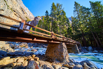 Bridge crossing over icy river in national park of Yosemite