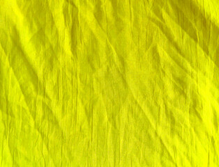 beautiful natural yellow crumpled cotton textile background. suitable for designs and art projects