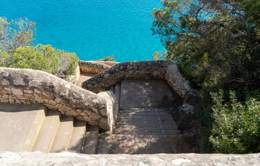 old stone stairs to the beach and the mediterranean sea at mallorca island