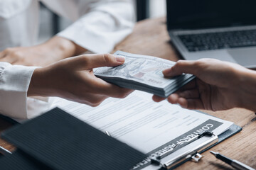 Home and Real Estate Selling Ideas, two people are real estate agents and a client is getting paid for the sale of the property after discussing the details and setting up a purchase agreement.