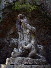 Fototapeta na wymiar Sculpture Bear family by sculptor Robert Stigell (1852-1907) in Aulanko park of nature reserve near Finnish Hamanlinna.