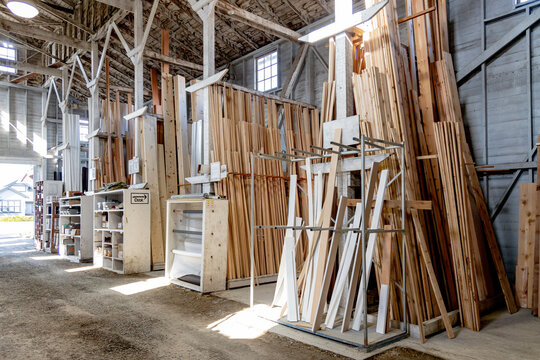 Small town lumberyard with wood for sale in a wooden building.