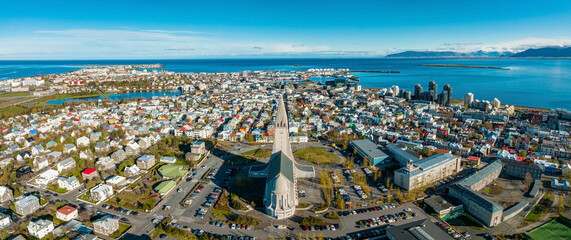 Aerial view of the Hallgrimskirkja Church in Reykjavik. Scenic view of Iceland in 4k. Hallgrimskirkja Lutheran Church. Statue of Leif Eriksson. - Powered by Adobe