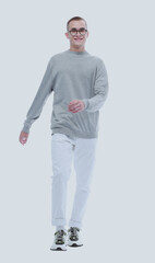 Fototapeta premium in full growth. smiling youngster in glasses goes forward